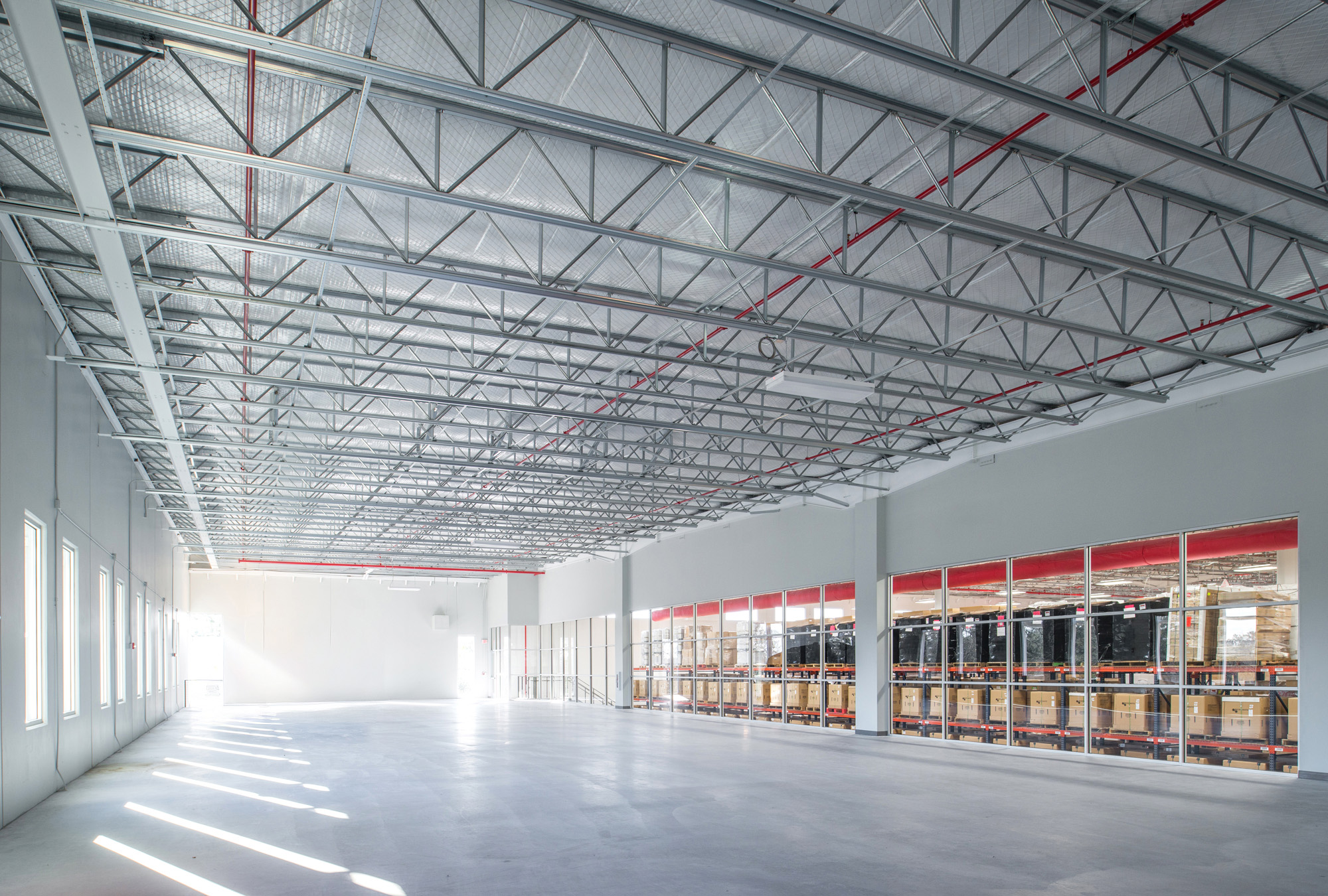 Micro Matic interior with exposed steel roof trusses and white walls